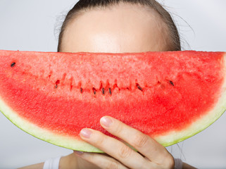 Young lady with a slice of water melon. Closeup