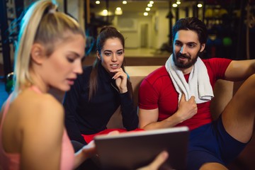 Group of friends relaxing after the training. Friends having conversation after exercising.Group of friends relaxing after the training. Friends having conversation after exercising.