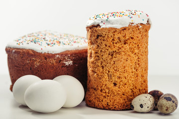 close-up view of sweet homemade easter cakes with chicken and quail eggs on grey