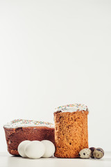 sweet homemade easter cakes with chicken and quail eggs on grey