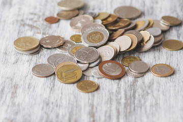 Different collector coins on the wooden background