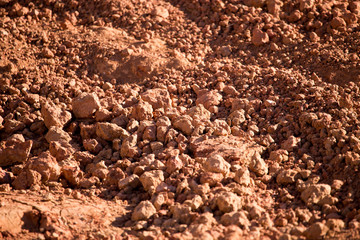 Red clay soil on nature as a background