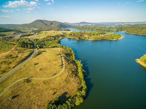 Aerial panorama of Lake Burley Griffin, Tuggeranong parkway, and iconic Telstra Tower in Canberra, ACT, Australia