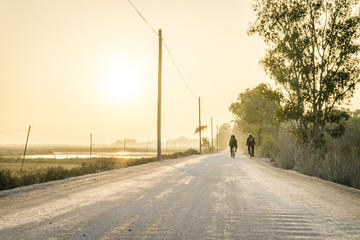 Two bicycle riders on a dust road in Algarve, Portugal