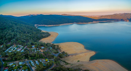 Aerial panoramic landscape of Lake Burrinjuck and holiday park at sunset. NSW, Australia