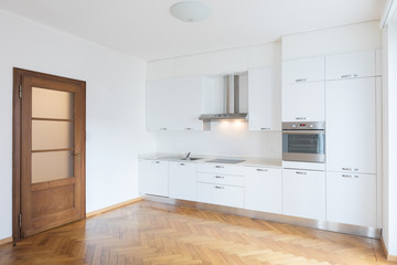 Kitchen in newly renovated open space with wooden floors