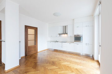 Kitchen in newly renovated open space with wooden floors