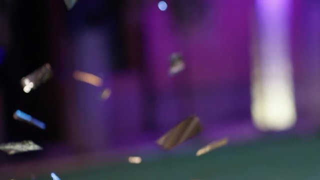  00:06 | 00:24 1&times;  Close up of falling down chrome glitter, confetti on party background. Shot on RED EPIC Cinema Camera in slow motion.