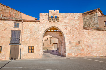 Fototapeta na wymiar exterior medieval arch in public street, ancient gate and main access to old town, famous landmark and monument in Ayllon village, Segovia, Spain, Europe 