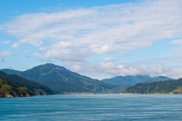 Landscape of the Mountain and sea with cloudy in the morning. View from the ferry to  South Island, New Zealand.