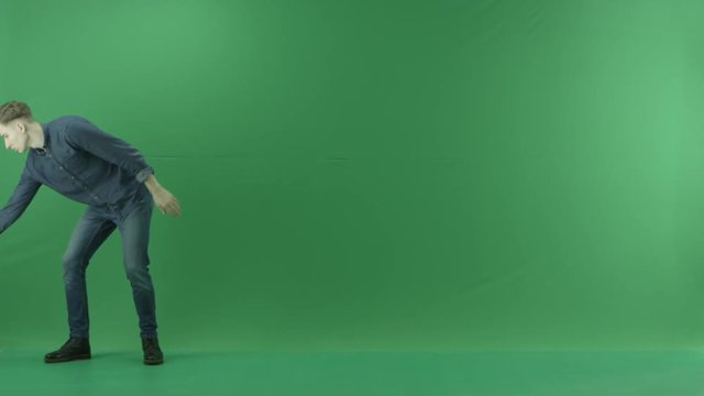 Young Man Showing Rainy Weather On The Left Side On The Green Screen