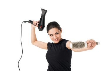 Female hairdresser fooling with dryer and hairbrush isolated on white