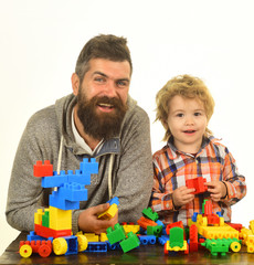 Parenthood and game concept. Man with beard and boy