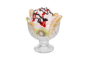 Dessert of ice cream vanilla, whipped cream, kiwi, banana, chocolate and berry topping, split, on a white isolated background in a transparent glass. Dish for menu in the cafe, restaurant. side view