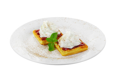 Thick wafers with berry red jam and whipped cream top with a sheet of mint on a plate on a white isolated background. Dessert for a menu in a cafe, restaurant, coffee shop side view