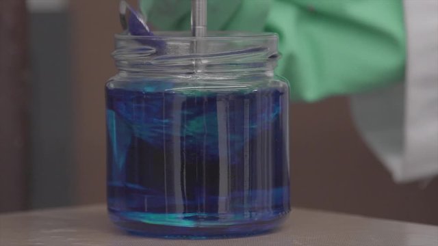 Nice macro shot ! Mix blue powder with water in a chemistry laboratory.