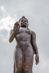 standing Buddha statue on Doi Pukha above Golden Triangle at view point of Kong river in Chiang Rai Thailand