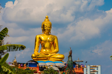 sitting golden big Buddha statue at Golden Triangle at view point of Kong river in Chiang Rai Thailand