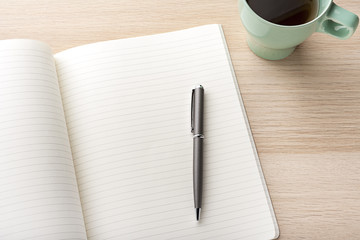 blank notebook with pencil on wooden desk