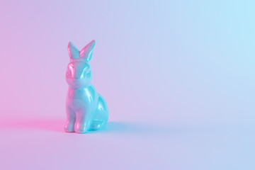White Easter bunny with colorful ultraviolet holographic neon lights. Creative concept.