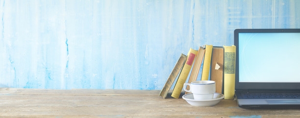 row of books,cup of coffee and laptop, learning, education, panorama, copy space