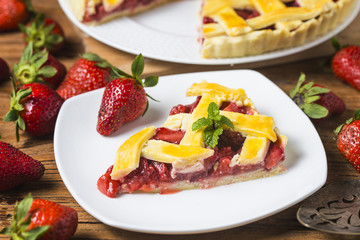 The strawberry pie in the wooden background