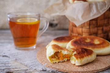 homemade cabbage pies on the table and lemon tea © androsov858
