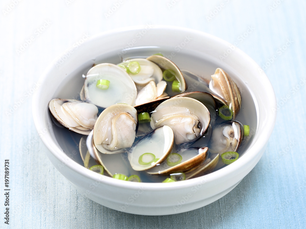 Wall mural Clams soup cooked in a white pot in recipe