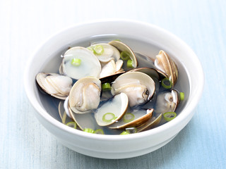Clams soup cooked in a white pot in recipe