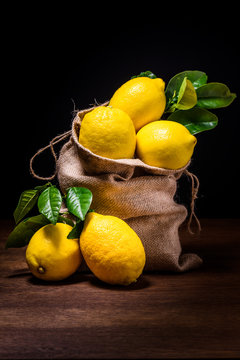 still life of fresh limines on dark wood
