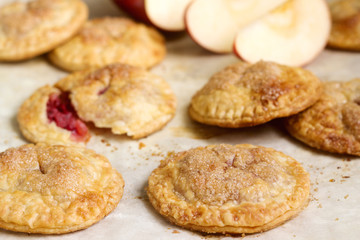 Crispy mini pies with apple and red currant. Rustic style.
