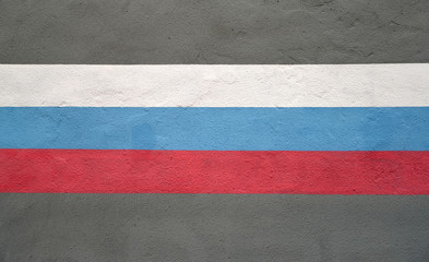 Fototapeta premium The flag of the Russian Federation is drawn on a building wall