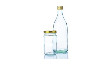 Empty clear glass bottles in various sizes and shapes with lids on white background