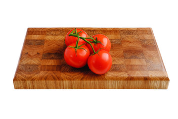 Branch of fresh red tomatoes on the kitchen cutting board isolated on white