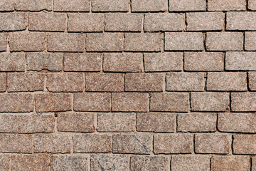 Stone granite cobblestoned pavement background or texture. Abstract background of old cobblestone pavement