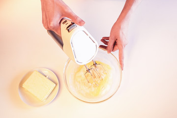 Making dough by female hands on white table
