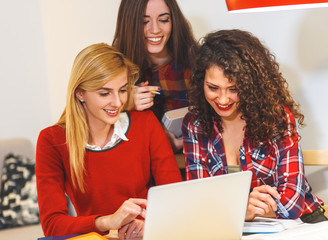 Group of female students study at home, learning for university exam.