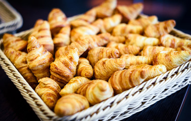 Fresh Croissants in a basket in buffet line.