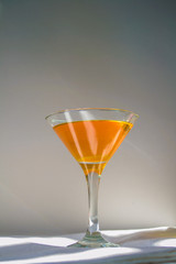 Orange drink with green leaves in a glass