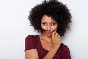 Close up beautiful african woman holding hair on face like moustache