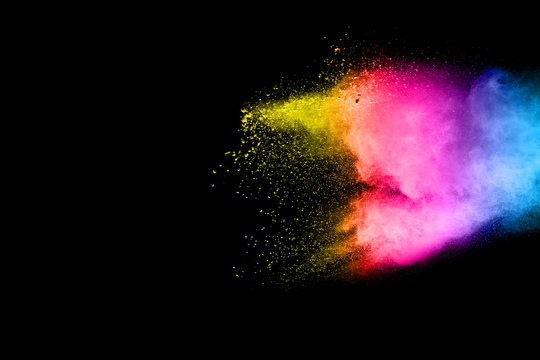 Abstract multicolored powder explosion on black background.  Freeze motion of color dust  particles splash. Painted Holi.