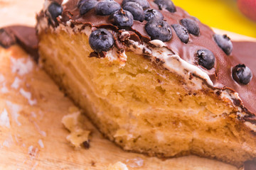 Chocolate cake made of chocolate pancakes with glaze, with blueberries. Vintage style.