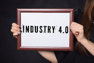 Fototapeta na wymiar In the hands of a businessman a frame with the inscription:INDUSTRY 4.0