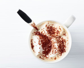 Hot chocolate and marshmallow sprinkled with chocolate chips.