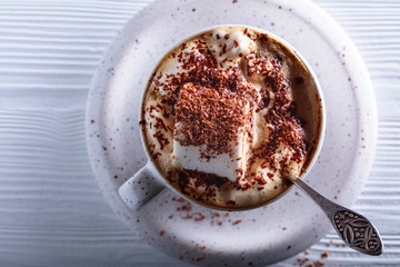 Hot chocolate and marshmallow sprinkled with chocolate chips.