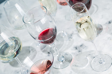 Wine tasting concept - glass with different wine on marble background