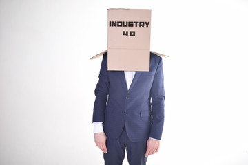 The businessman is holding a box with the inscription:INDUSTRY 4.0