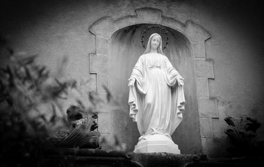 Statue of Madonna with stars nimbus on the front of Cathedral of Notre Dame of Assumption in...