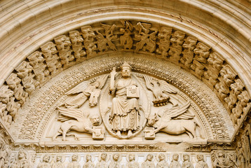 Church of St. Trophime in Arles. Jesus Christ surrounded by Four Evangelists (represented as winged man, lion, ox and eagle) and angels above entrance to church. Provence, France.  - obrazy, fototapety, plakaty
