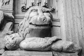 Lion devouring the sinner. Architectural detail. Facade of the church of St. Trophime in Arles, Provence, France. Balck wjite historic photo